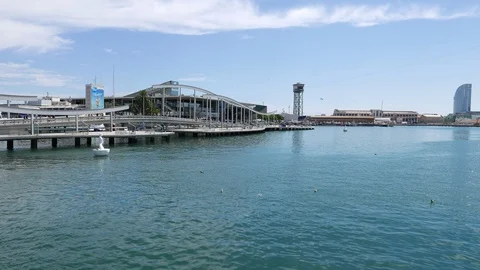 Boating along Rambla del Mar boardwalk at Barcelona Port Vell Stock Footage 102320688