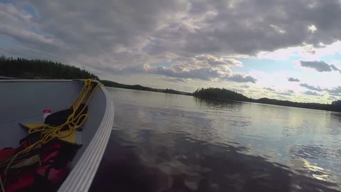 Boating on a calm lake with a cloudy sky Stock Footage 77810325