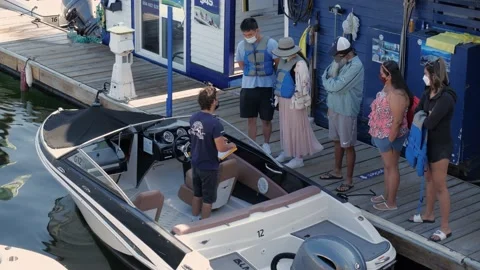 Boating instructor instructing people how to operate boat. 스톡 동영상 157405228