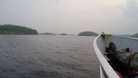 Boating on a lake with an overcast sky Stock Footage 77810381