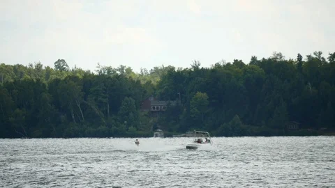 Boating in Minnesota. Water skier pulled by speed motor boat. Stock Footage 104225877