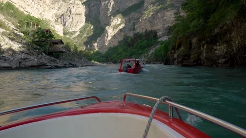 Boating in the mountain river in Dagestan with red boats Video stock 186973268