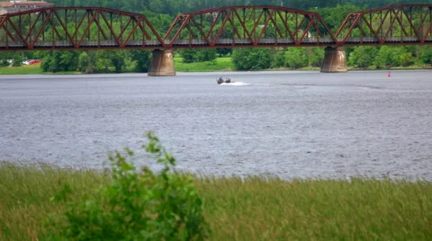Boating on a River close to an Old Train Bridge. Stock Footage 64910722
