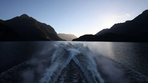Boating through lake surrounded by waves Stockbeeldmateriaal 89722969