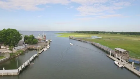 Boating on the water in a creek with docks Stock Footage 75969062