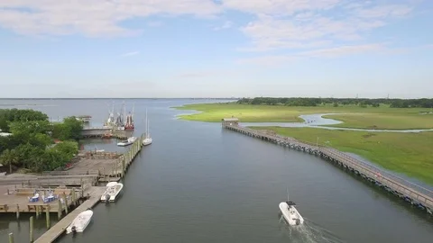 Boating on the water in a creek with docks Stock Footage 75969128