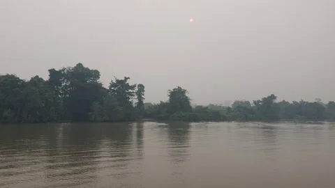 Boating on a West Kalimantan river surrounded by white smoke Stock Footage 345864689