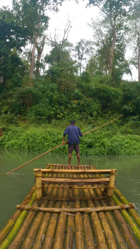 Boatman Bamboo Rafting on Kanger River with Bamboo Stick Stock Footage 280657288