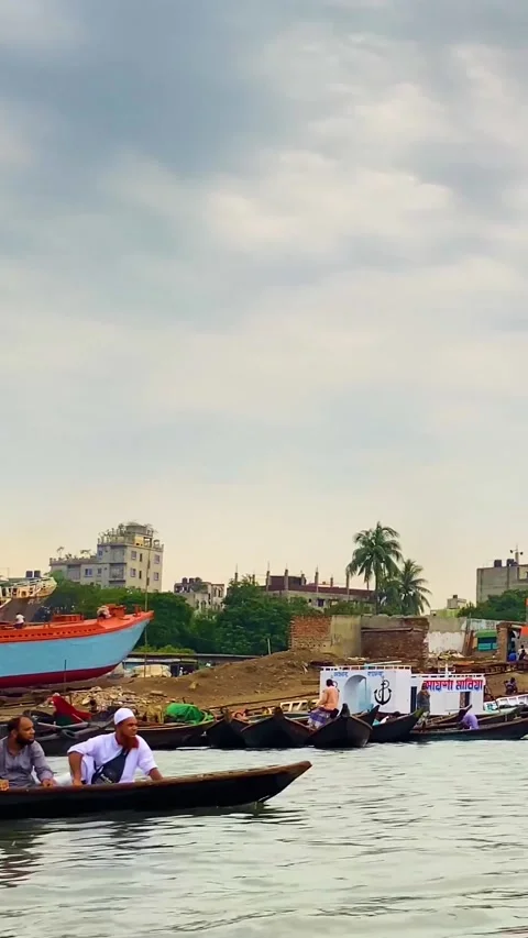 Boatman rowing small boat with passengers on Buriganga River at Sadarghat in Stock Footage 331696898