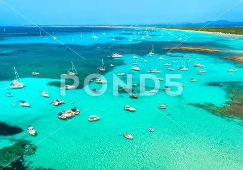Boats and luxury yachts in transparent sea at sunrise Stock Photos