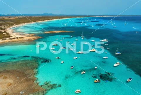 Boats and luxury yachts in transparent sea at sunset in summer Stock Photos