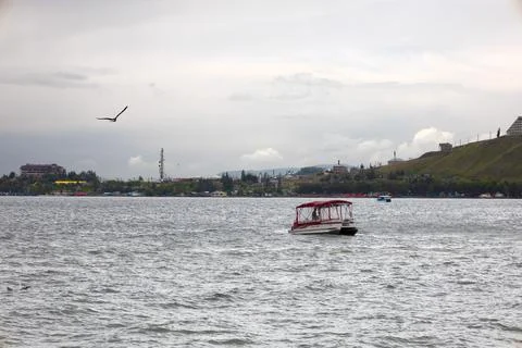 Boats and seagull on lake Sevan Stock Photos