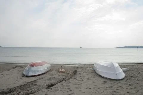 Boats on the beach on a rainy day Stock Photos