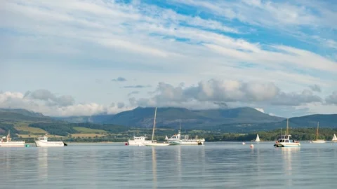 Boats off the coast of Beaumaris with dramatic clouds over the Menai Straight Stock Footage 255230160