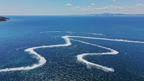 Boats create waves in blue water on sunny day in the open sea Stock Footage 339652748