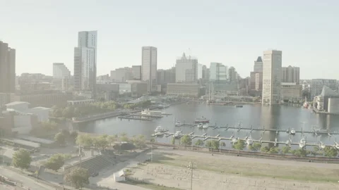 Boats cruising through the water while people play volleyball on shore Stock Footage 145421660