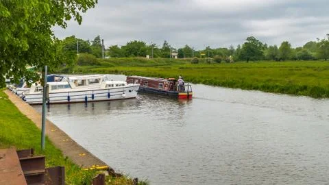 Boats of differing types and sizes line the banks of the River Great Ouse Stock Photos
