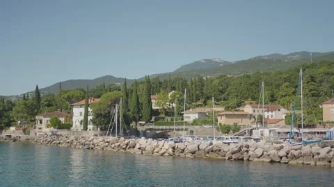 Boats docked in a harbor with mountains in the background Stock Footage 277513236