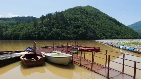Boats on the Drina river. Garbage floating on the river Stock Footage 264766229