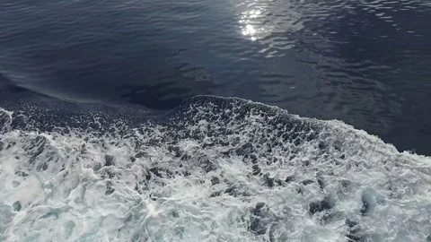 Boat's engine churn sea into waves and wakes, top view, LOOP Stock Footage 80036575