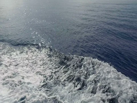 Boat's engine propellers churn the sea into waves and wakes Stock Footage 80053313