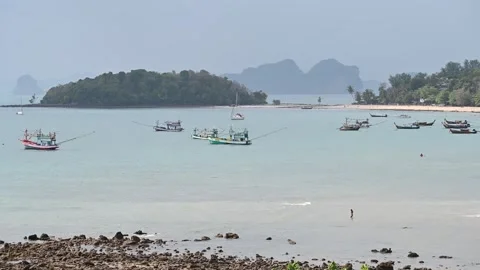 Boats float across Klong Muang Beach shoreline Video stock 336717619