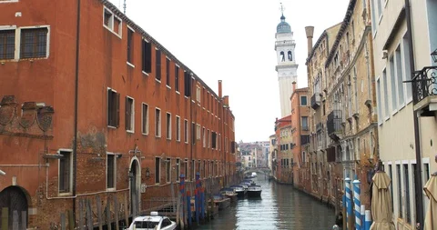 Boats float on back canals in Venice Italy. View of beautiful historic building Stock Footage 119909573