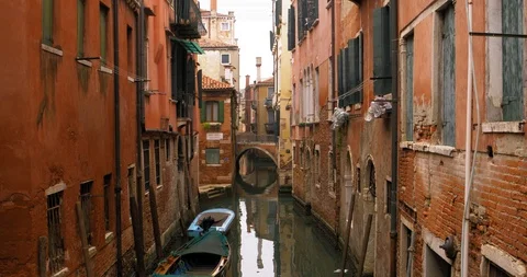 Boats float on back canals in Venice Italy. Shot filmed in 4k 2160p Stock Footage 120417406