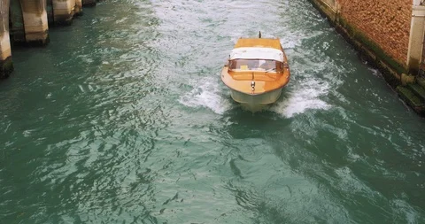 Boats float on back canals in Venice Italy. Shot filmed in 4k 2160p Stock Footage 120418076