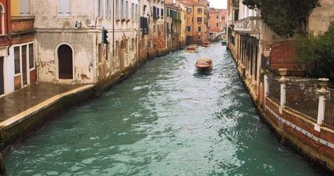 Boats float on back canals in Venice Italy. Shot filmed in 4k 2160p Video stock 120418082