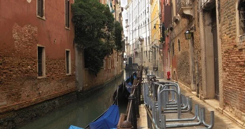 Boats float on back canals in Venice Italy. Shot filmed in 4k 2160p Stock Footage 120419380