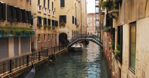 Boats float on back canals in Venice Italy. Shot filmed in 4k 2160p Stock Footage 120419538