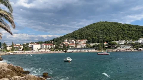 Boats float on the water with mountains in the background Stock Footage 283726796