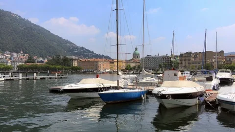Boats float on the waters of como lake with dome in the background Stock Footage 118649243