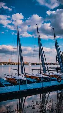 Boats in the harbor against the backdrop of clouds Stock Photos
