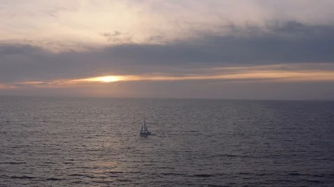 A boat's journey through wide Ocean on Sunset Stock Footage 100525933