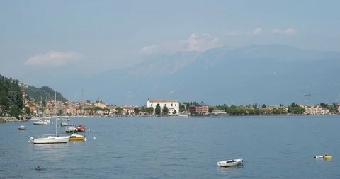 Boats on Lake Garda overlooking Toscolano Maderno Stock Footage