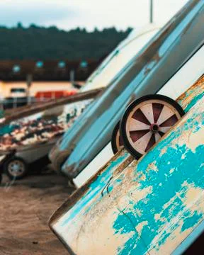 Boats leaning against a beach wall Stock Photos