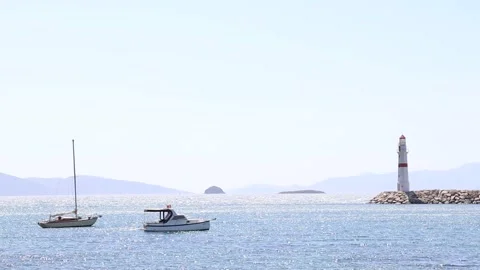 Boats by the Lighthouse (Slow Motion) Stock Footage 236663170