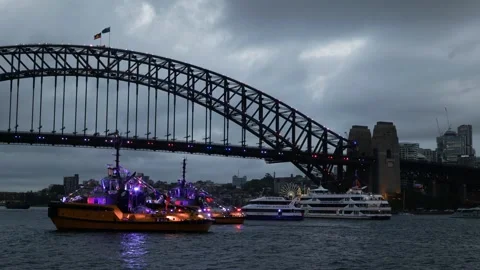 Boats lit up with Australian flags next to Sydney Harbour Bridge Australia Stock Footage 330445271