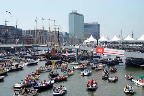 Boats meander about in IJ harbor Amsterdam during SAIL 2015. Stock Photos