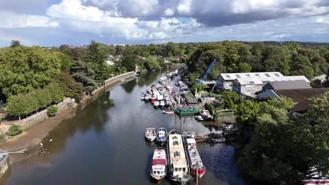 Boats moored Eel Pie Boatyard River Thames Twickenham UK drone,aerial Stock Footage 317295664