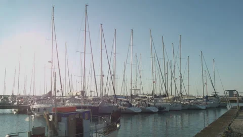Boats moored in harbor. A boat pass by. 库存影片 146295553