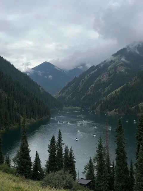 Boats on a Mountain Lake Surrounded by Forests Stock Footage 341318111