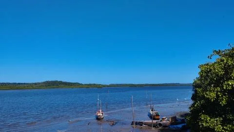 Boats On The Mud Flat Under Blue Sky Stock Photos