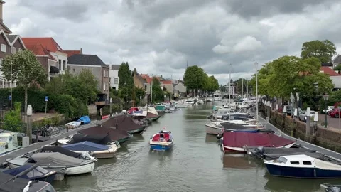 Boats at New Harbour. Tiny boat sails through canal. Dordrecht, Netherlands Stock Footage 338394835