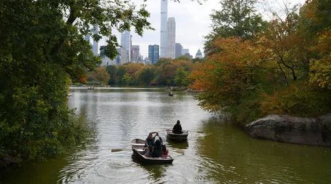 Boats paddling in New York City central park lake Stock Photos