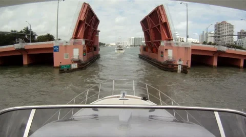 Boats passing under small bridge  Stock Footage 43229743