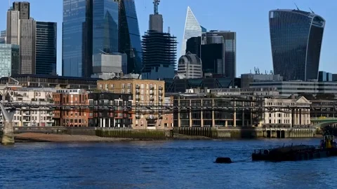 Boats quickly going under the Millennium Bridge towards the the City of Stock Footage 254750626