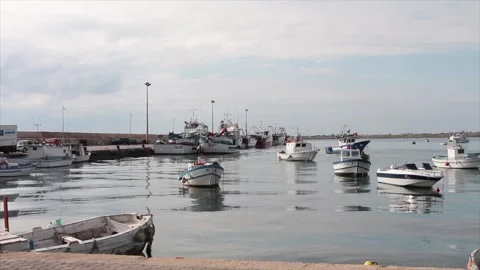 Boats resting sitting in water ocean off coast dock with clouds sky above Stock-Footage 252153530